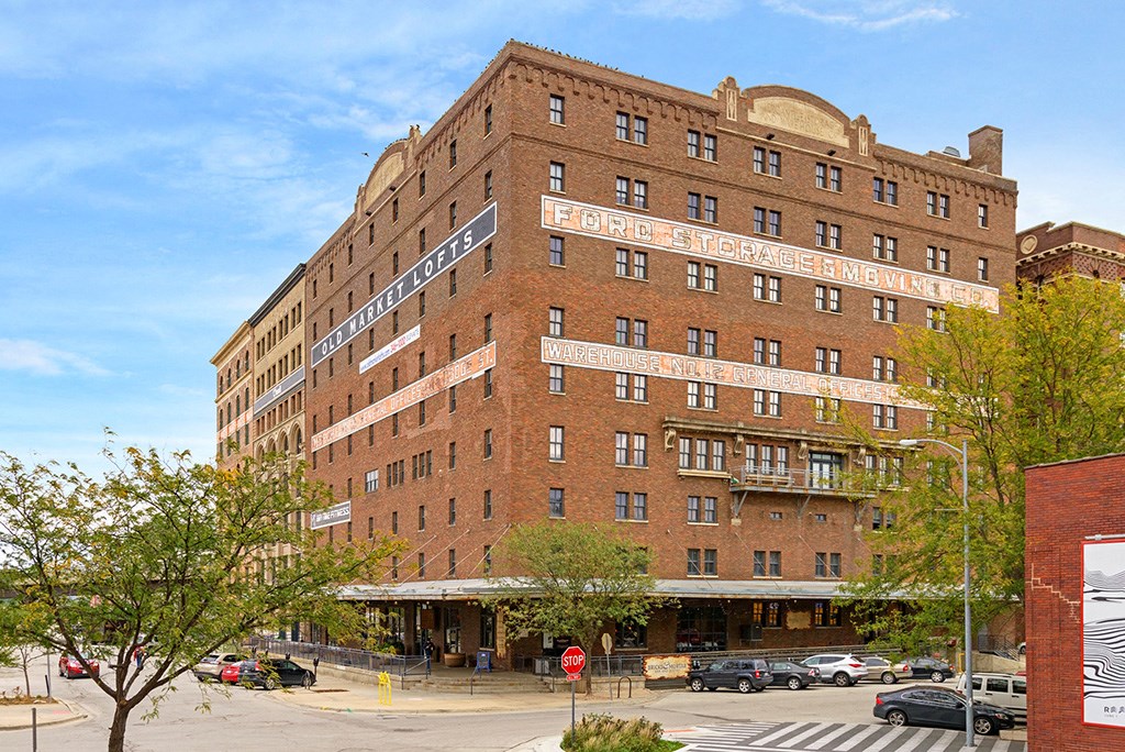 a tall brick building on the corner of a city street