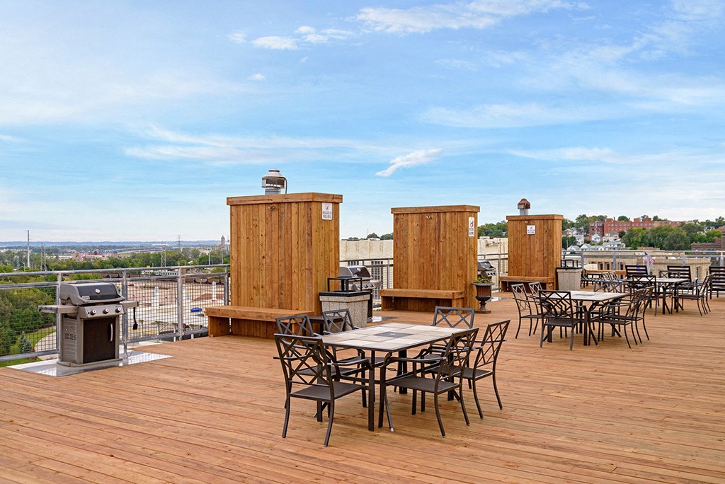 the terrace on the roof of the building has tables and chairs
