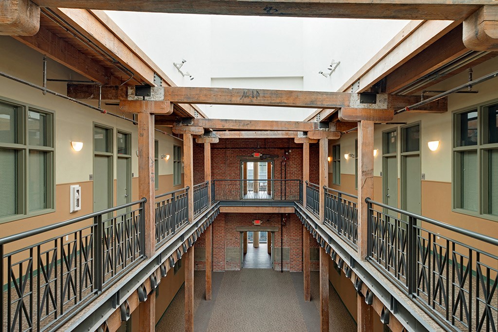 the interior of a building with a large hallway with railings and windows