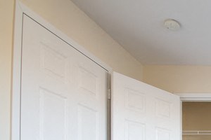 bedroom with two closets, off-white walls and carpeted floors