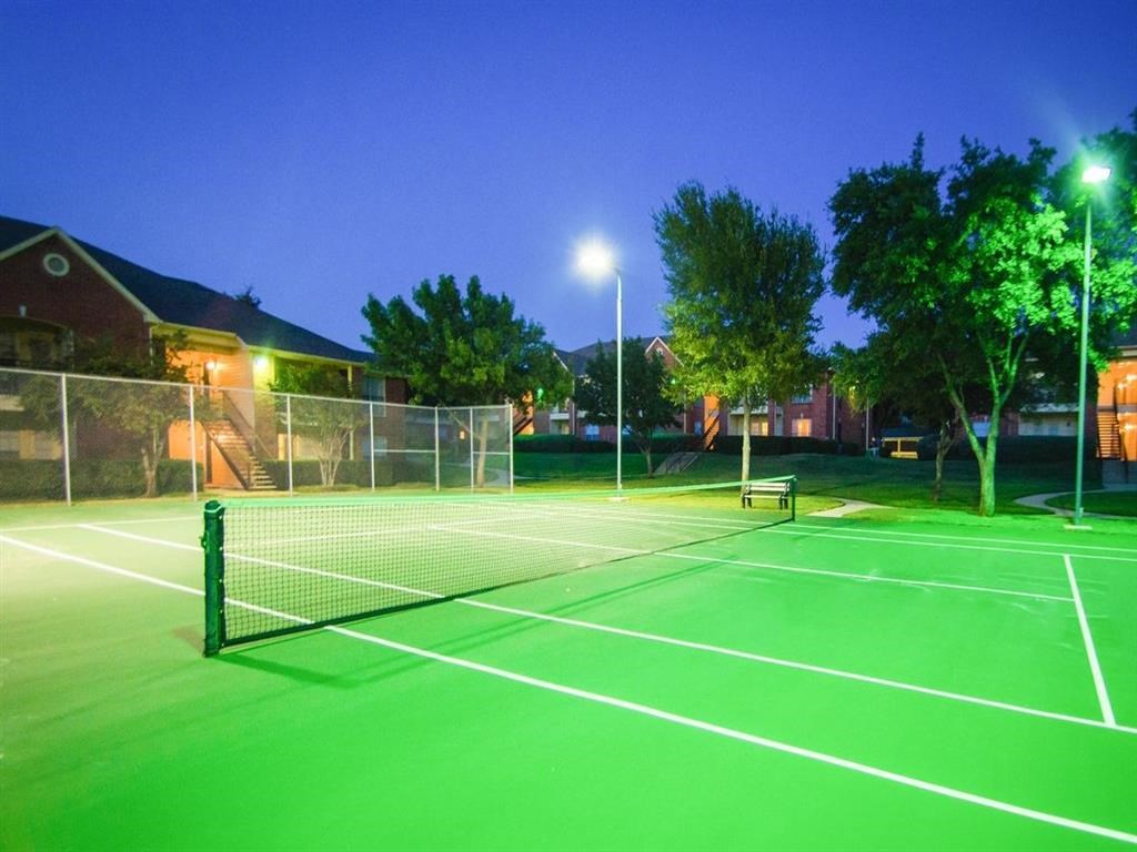 the tennis courts are lit up at night