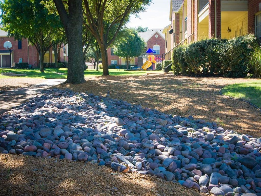 a pile of rocks on the ground in front of a building