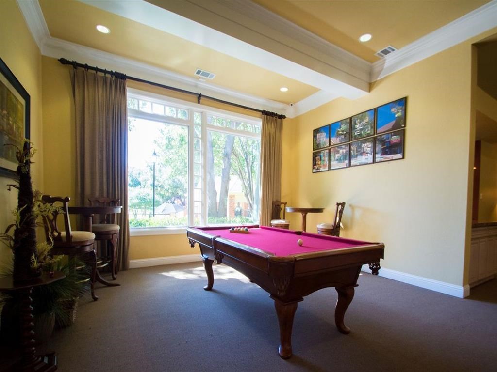 a game room with a pink pool table