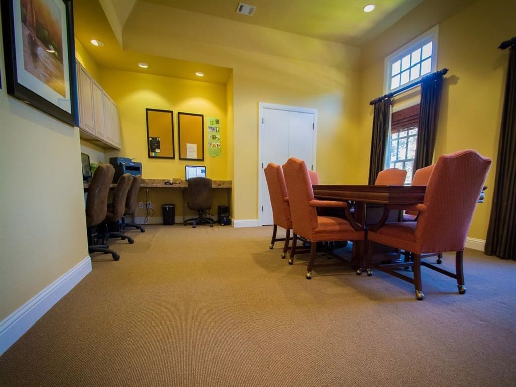 a conference room with a table and chairs