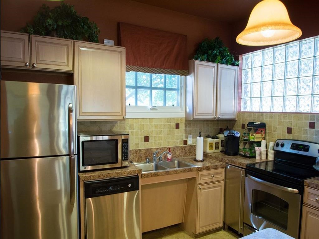 a kitchen with stainless steel appliances and white cabinets