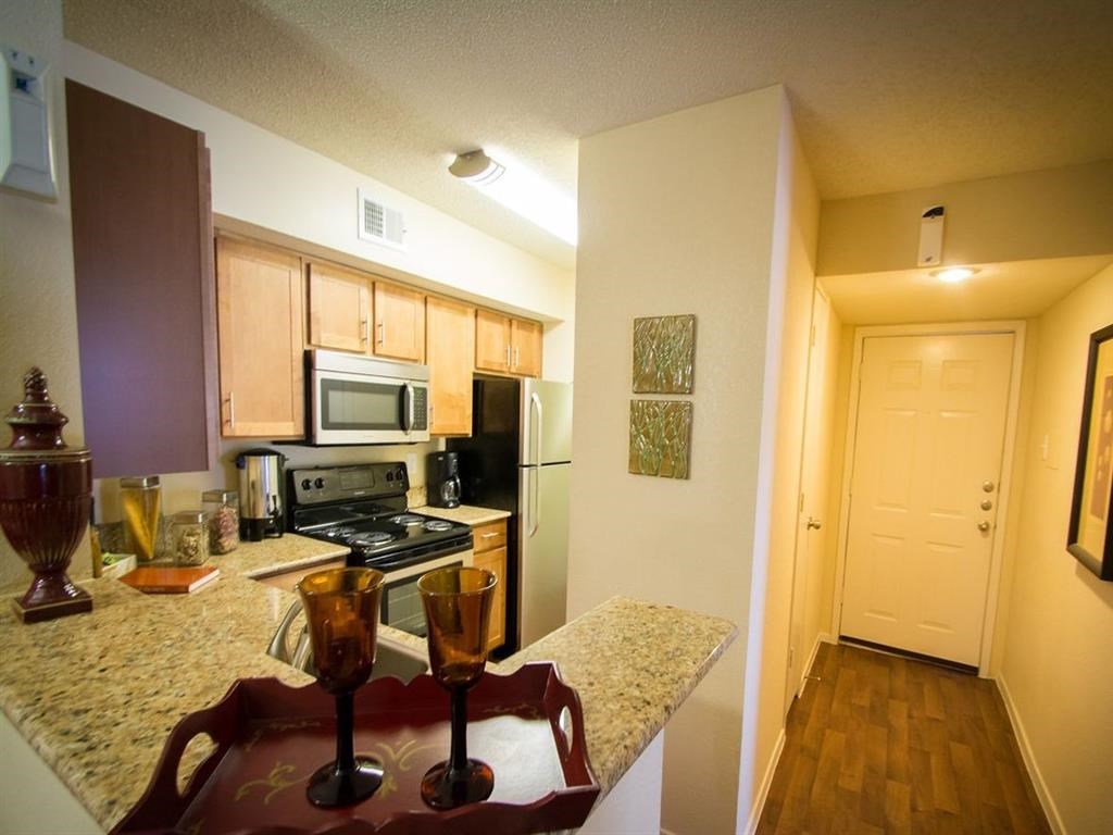 a kitchen with stainless steel appliances and granite counter tops
