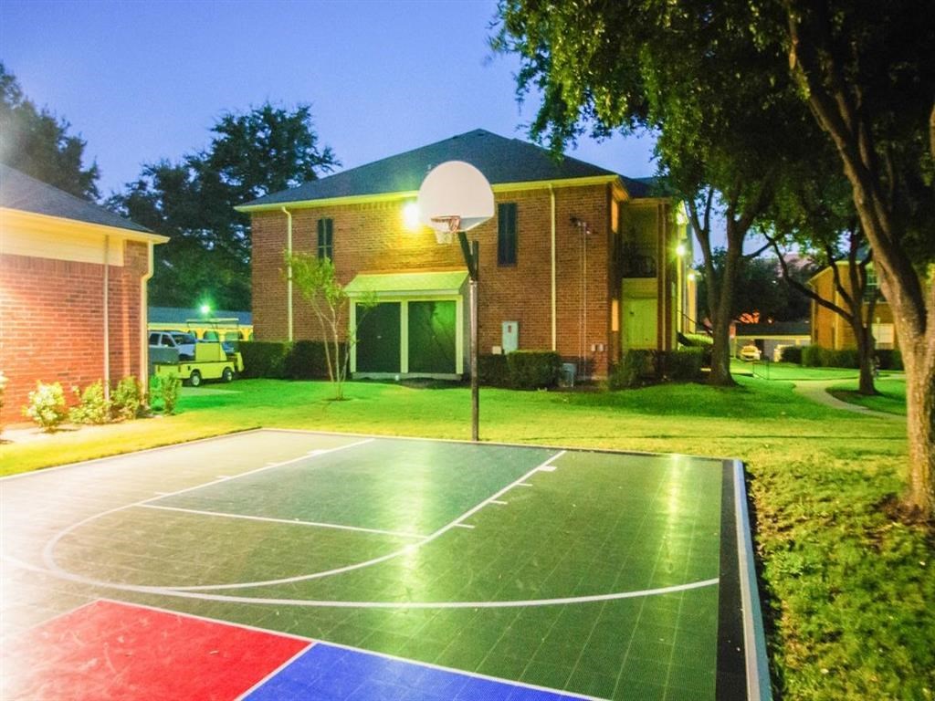 a basketball court in front of a house at night