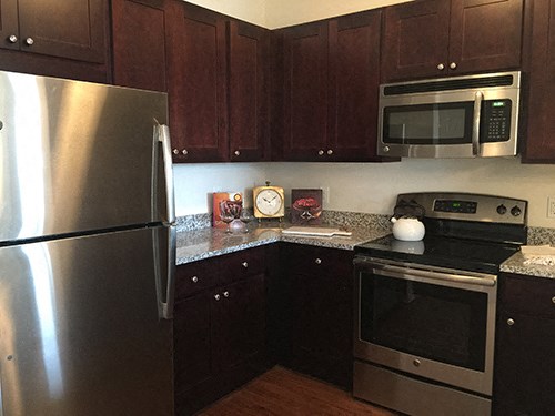 a kitchen with stainless steel appliances and wooden cabinets