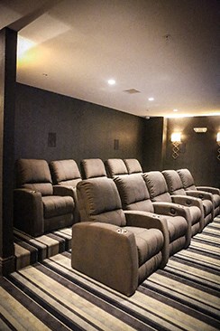 a large screening room with a row of reclining chairs