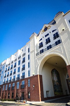 a large white building with a clock on the top of it