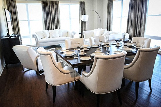 a dining room with a large table and chairs