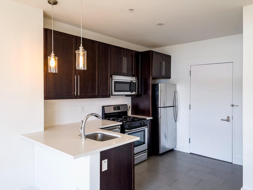 a kitchen with stainless steel appliances and wooden cabinets
