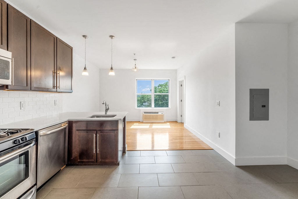 a kitchen with stainless steel appliances and wooden cabinets