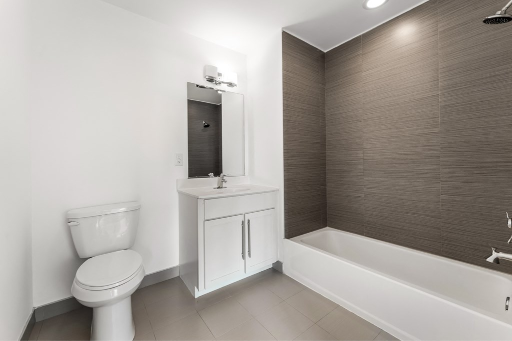 a white bathroom with a toilet and a sink