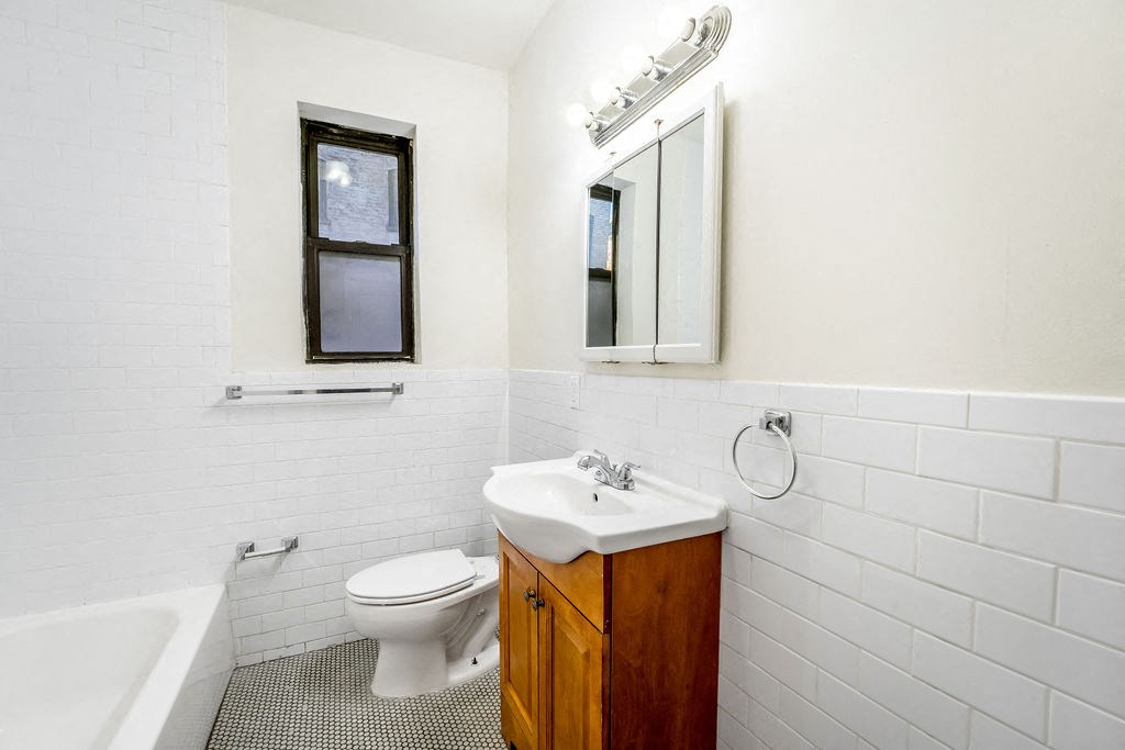 a living room with a hard wood floor and white walls