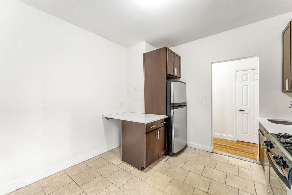 a living room with a hardwood floor and a window