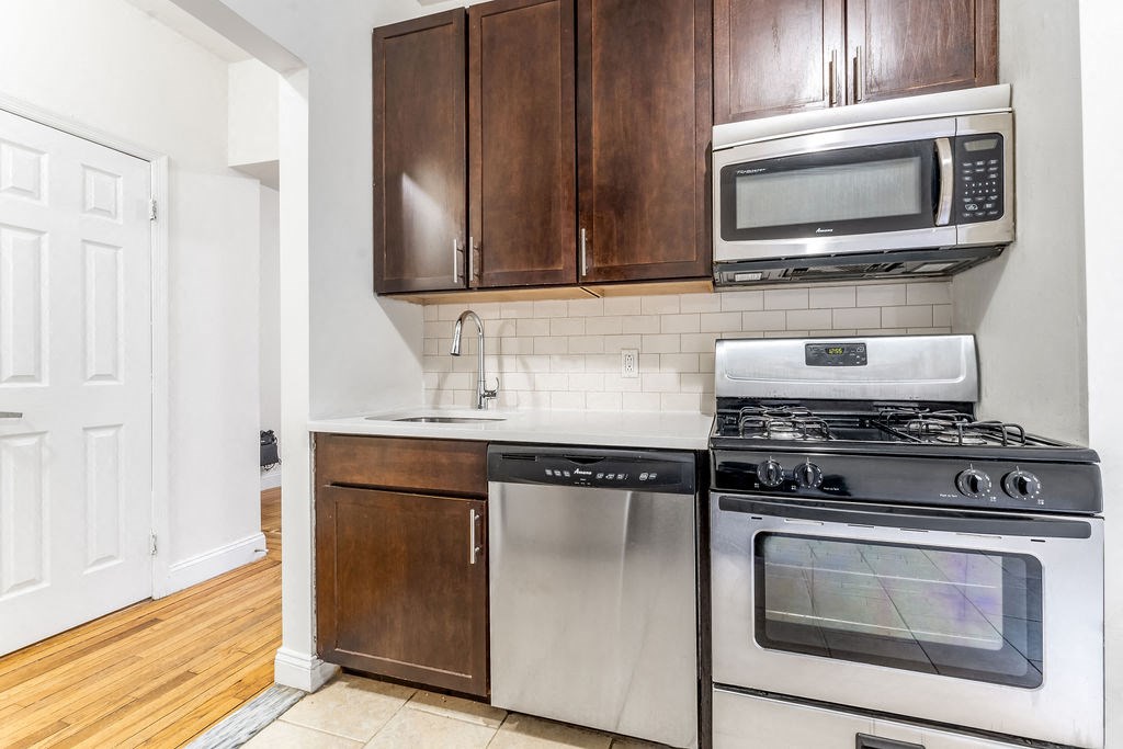 a living room with a hardwood floor and a window