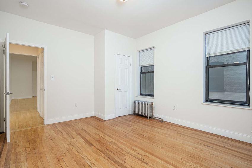 a living room with a hardwood floor and a window