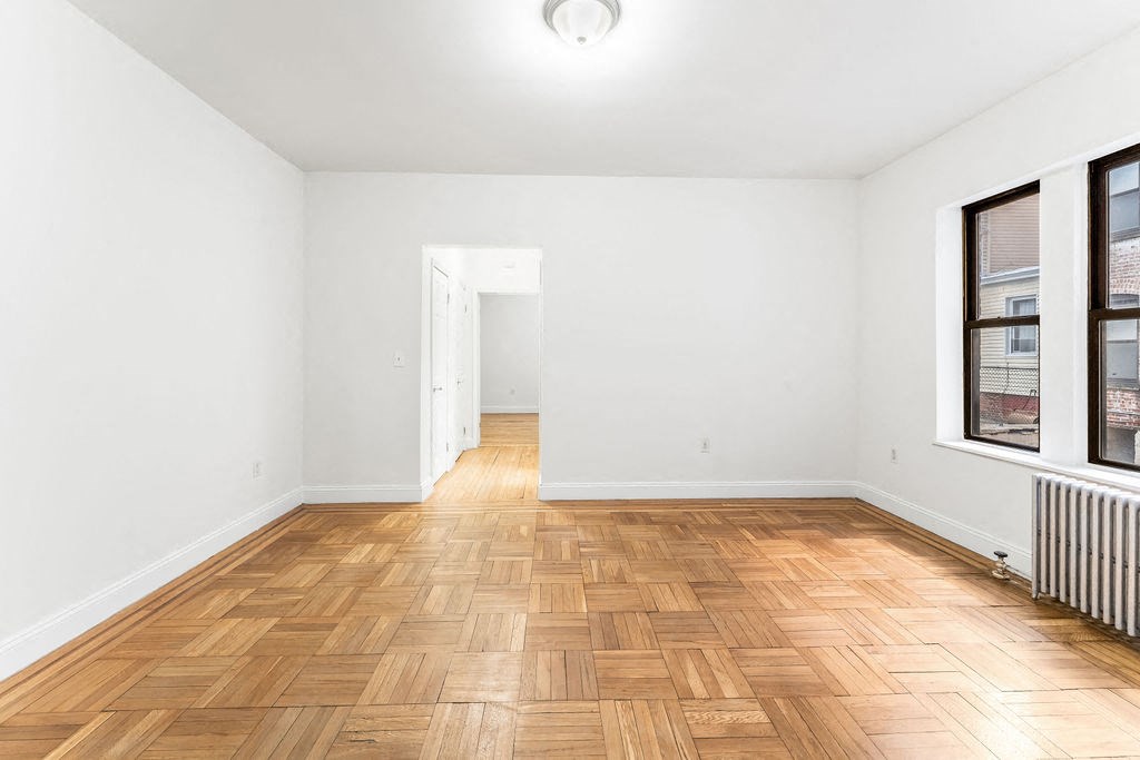 an empty room with a window and a closet