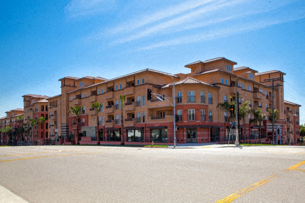 A large multi-story building with a parking lot in front.