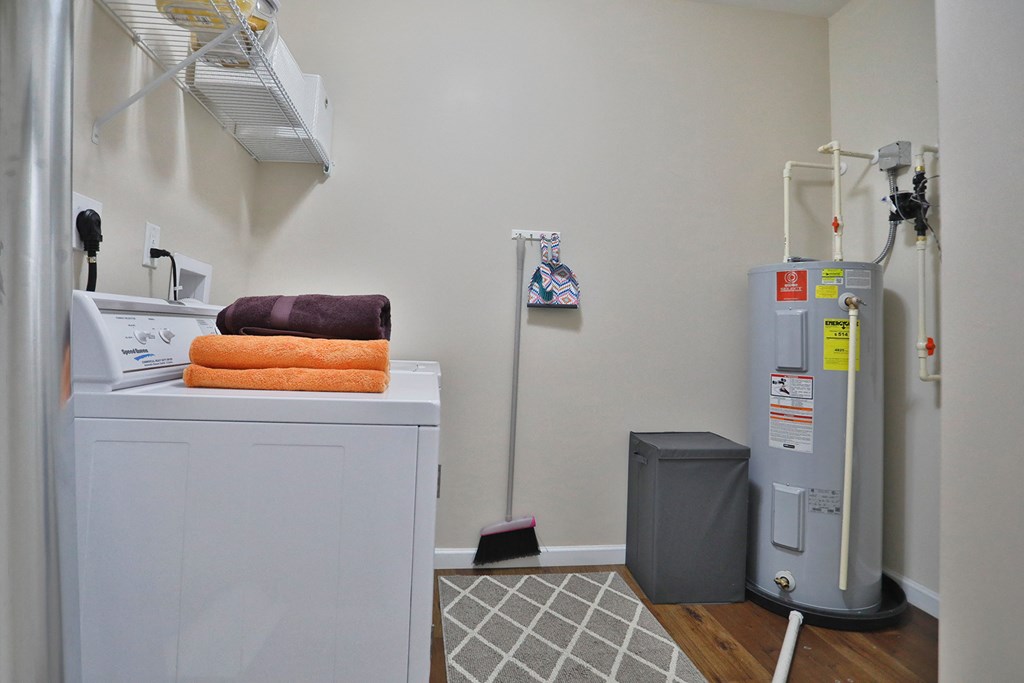 a laundry room with a washer and dryer and a water heater