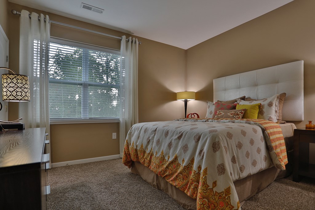 a bedroom with a bed and a window