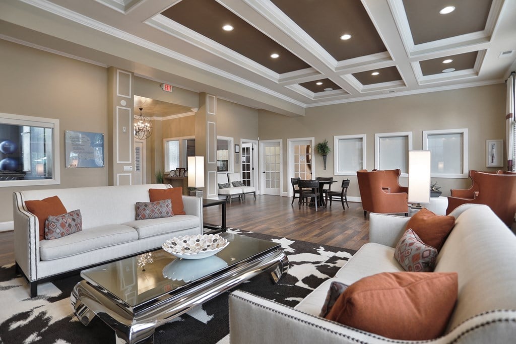 a living room with couches and chairs and a table