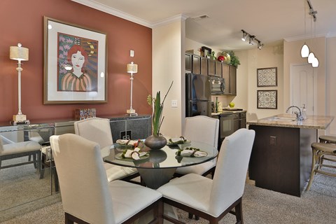 a dining room and kitchen with a table and chairs