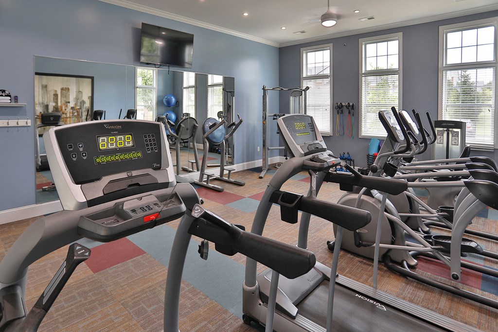 a gym with treadmills and other exercise equipment
