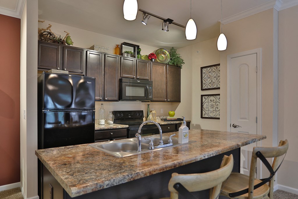 a kitchen with stainless steel appliances and granite counter tops