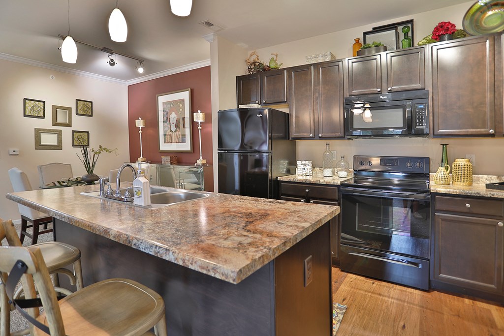 a kitchen with stainless steel appliances and a marble counter top