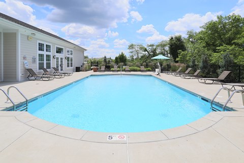 our resort style swimming pool is next to our building and has lounge chairs around it