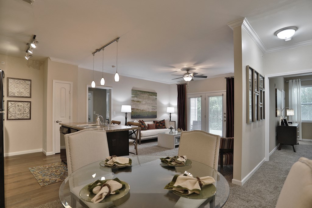a living room and dining room with a glass table