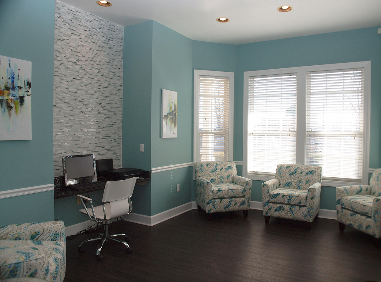 an office with blue walls and chairs and a desk
