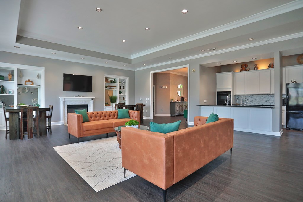 A living room with a brown couch and a television.