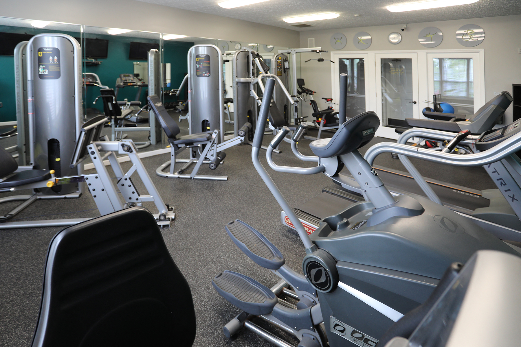 a gym full of cardio equipment and weights