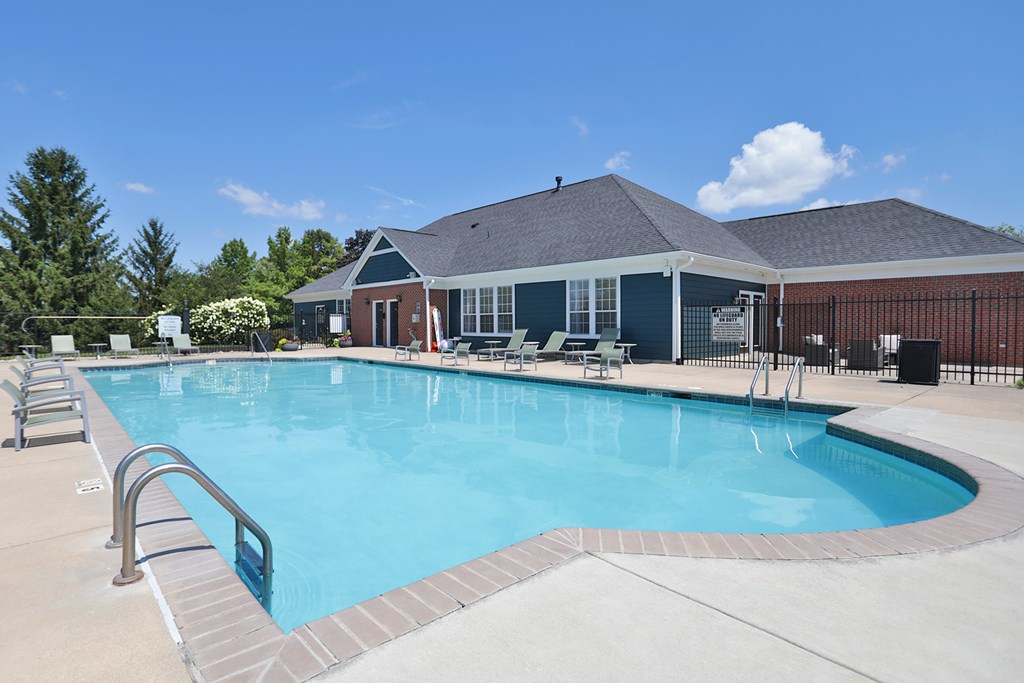 A large swimming pool with a metal ladder on the side.