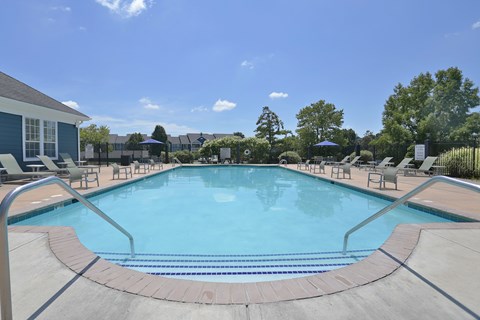 A large outdoor swimming pool surrounded by lounge chairs.