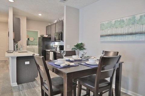 an open kitchen and dining room with a table and chairs
