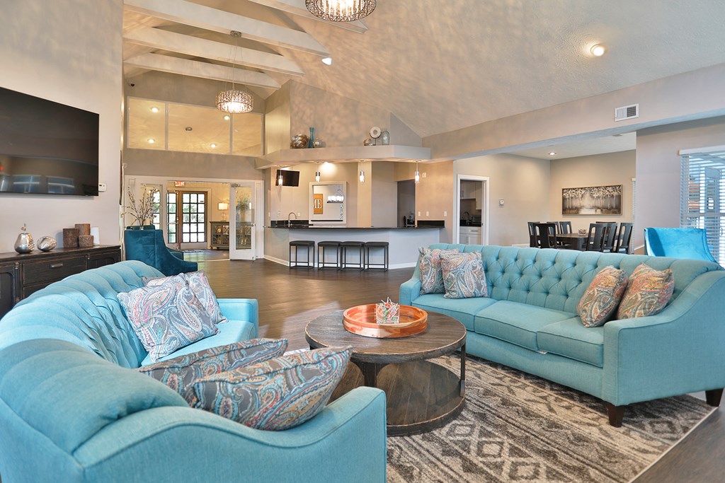 a living room with blue couches and a coffee table