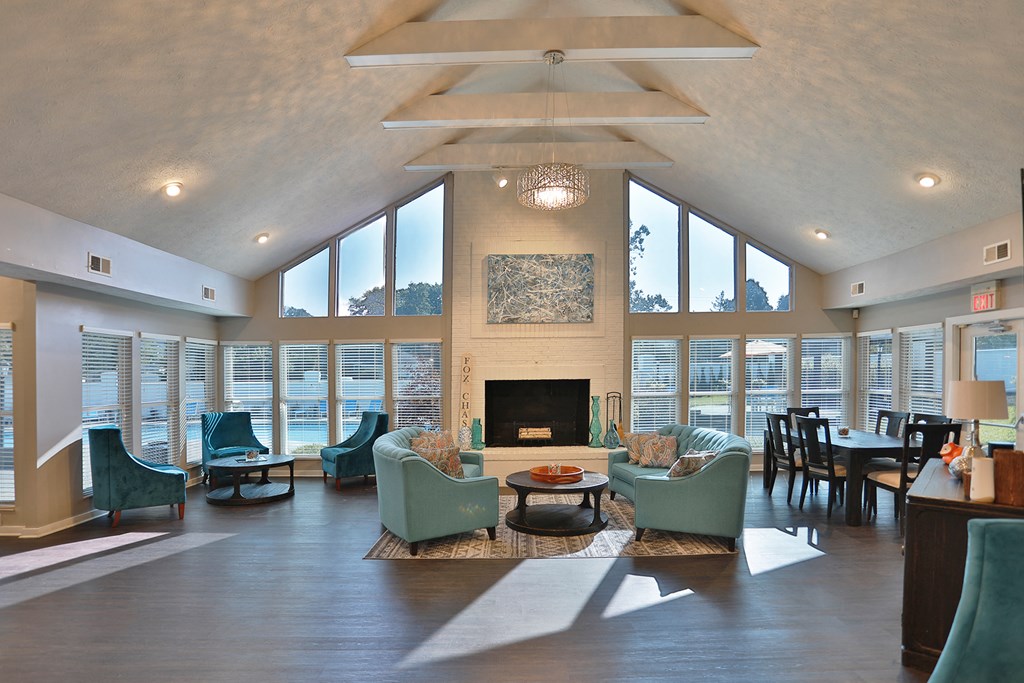 a large living room with a fireplace and large windows