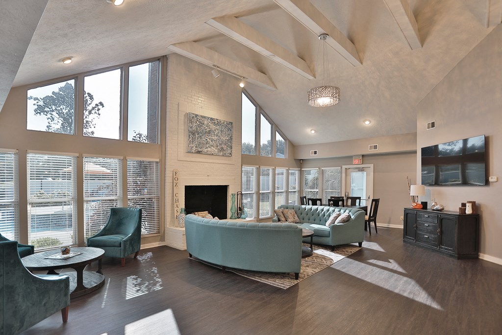a living room with couches and chairs and a fireplace