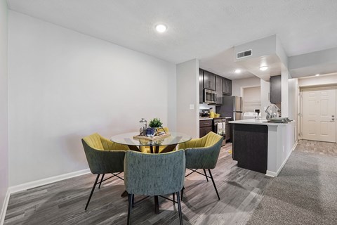 A dining area with a table and chairs.