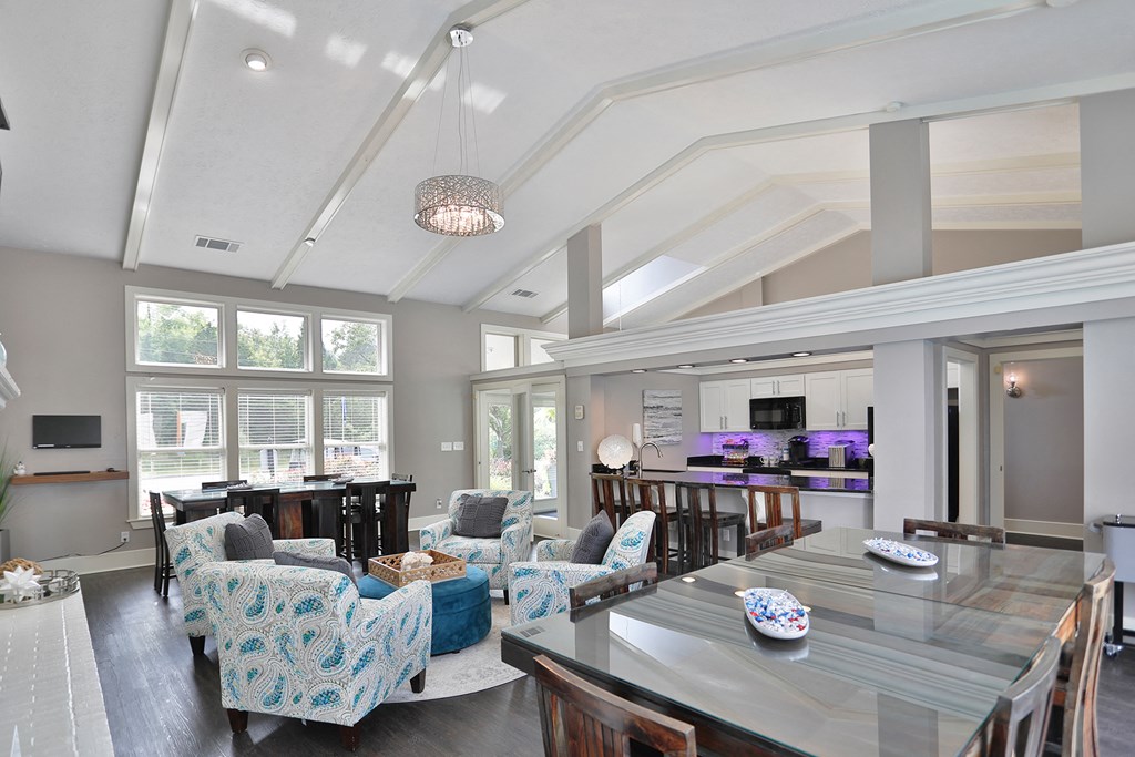 a living room and dining room with a large table and chairs