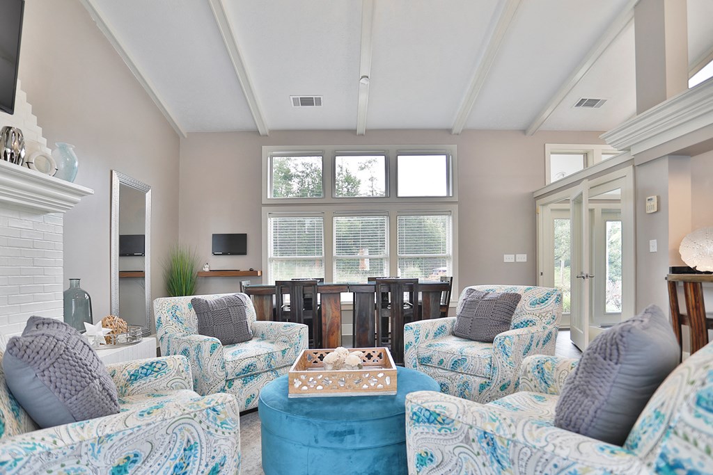 a living room with blue and white furniture and a large window