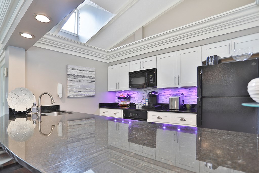 a kitchen with a counter top and a refrigerator