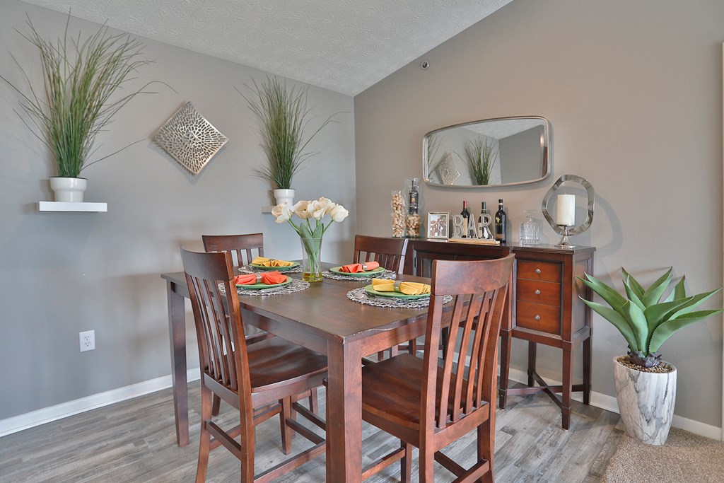 a dining room with a wooden table and chairs