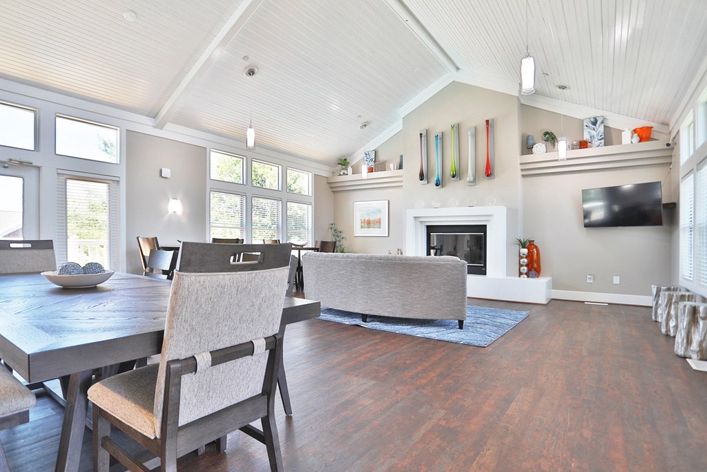 a living room with a table and chairs and a fireplace