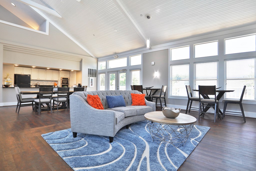 a living room with a couch and a coffee table in front of a large window