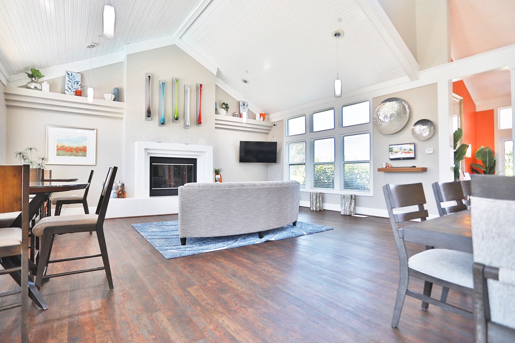 a living room with a fireplace and a table and chairs
